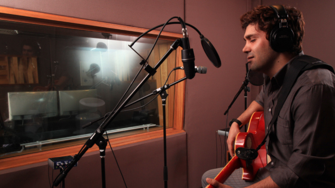 man singing inside a studio