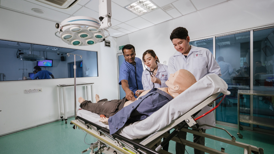 students and lecturer working on a dummy