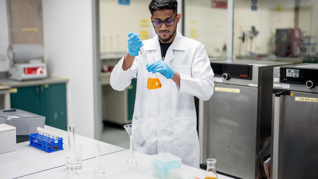man working with test tubes and liquids