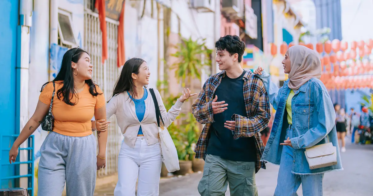 Students have fun hanging out together in a city.
