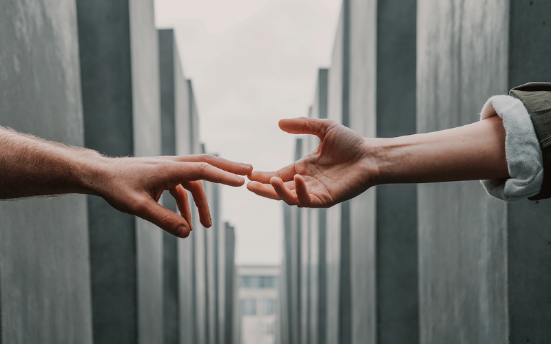 Two hand touching at each others finger tips