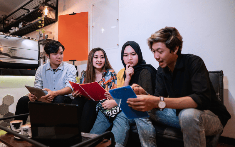 Young and happy teenagers studying together