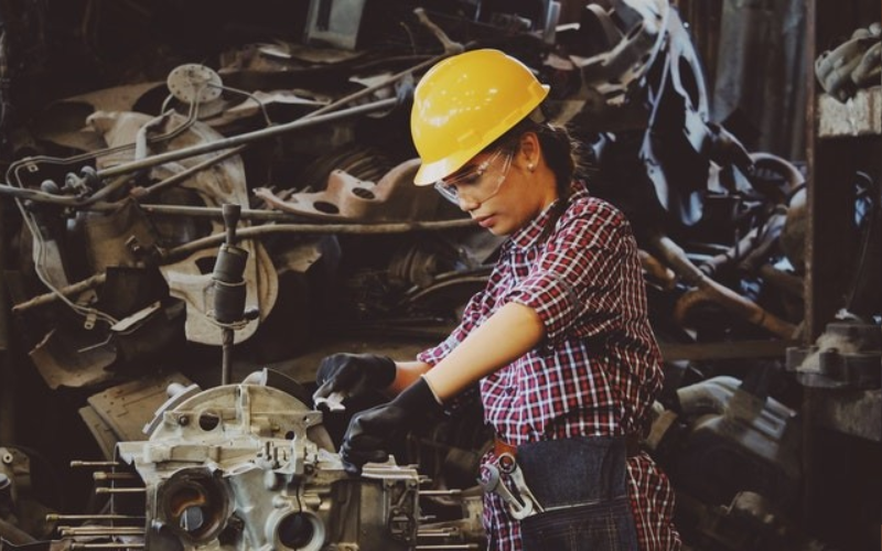 Woman working on an engine