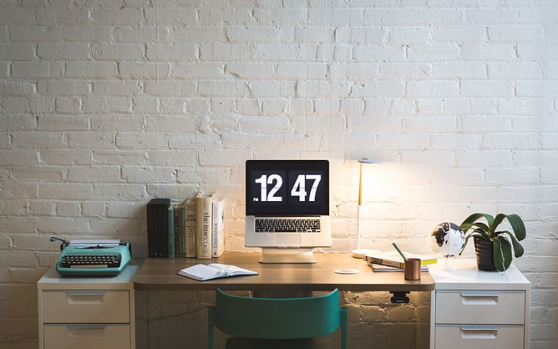a study desk with books and laptop