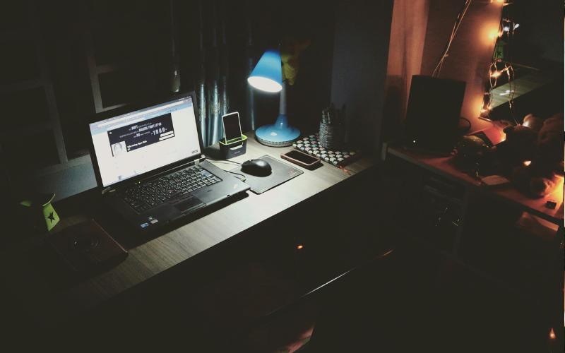 Picture of a laptop in a dark room
