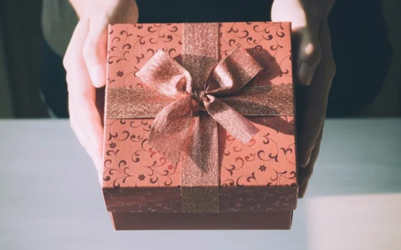 a person gifting a present