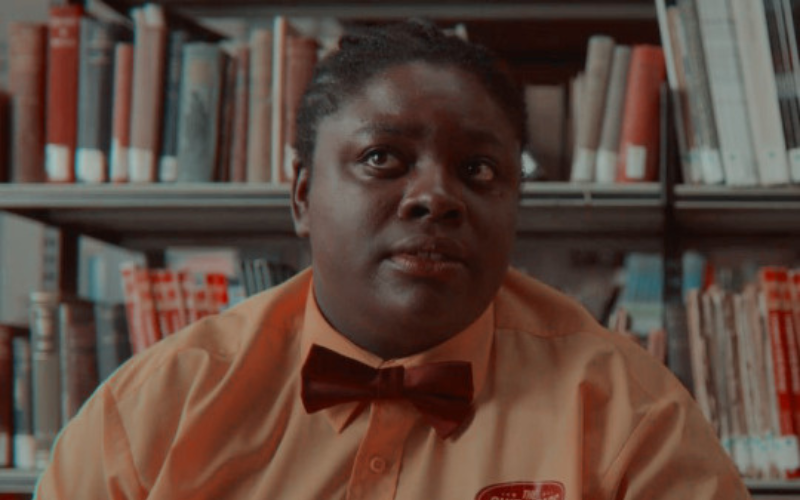 girl in front of a bookshelf