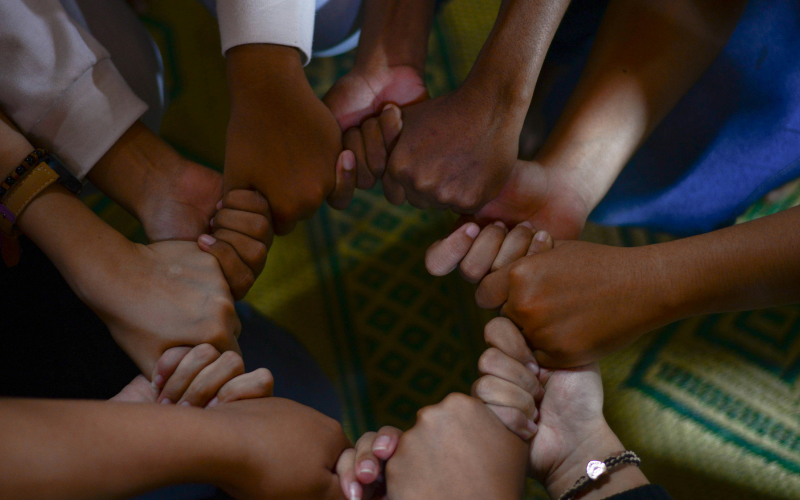 Picture of people linking their hands together