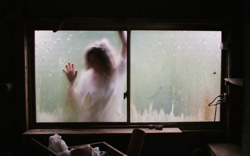 scary person at a glass