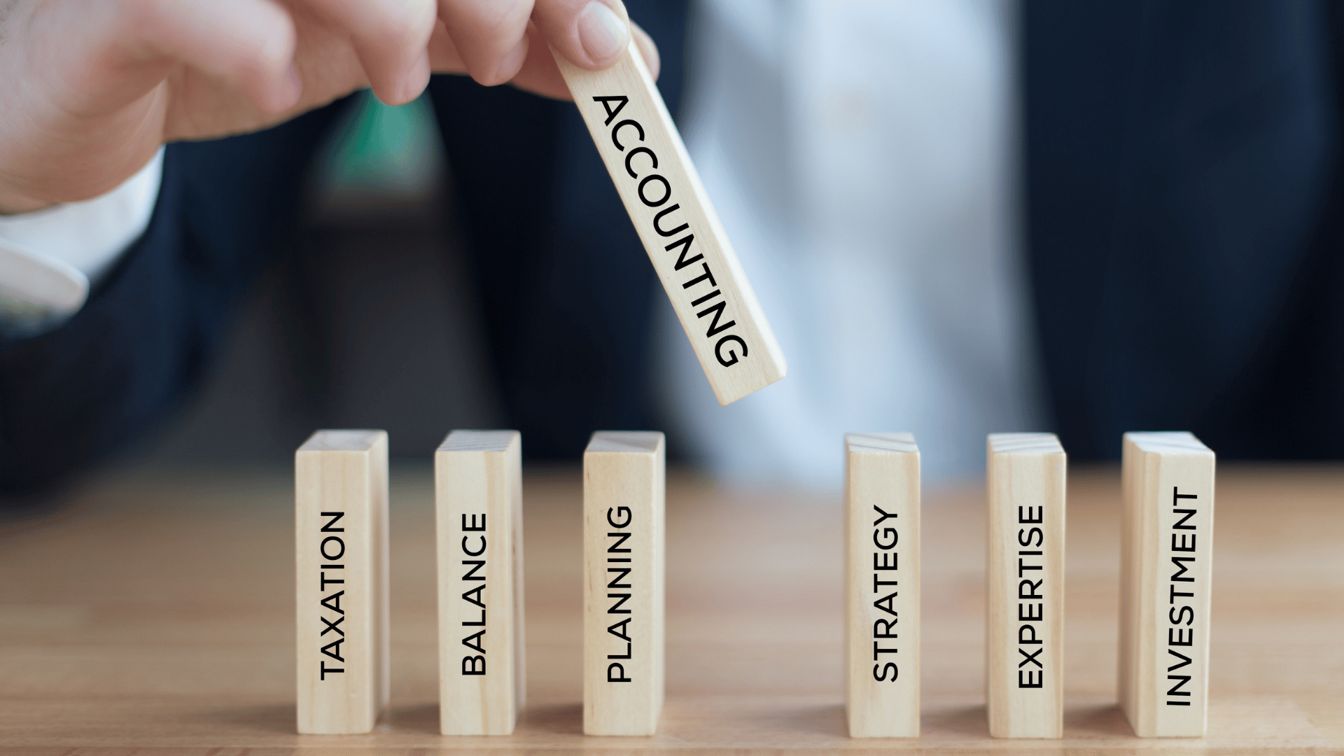 A hand chooses accounting block from the rest of the blocks