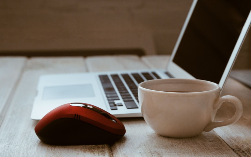 A coffee and laptop are on the table