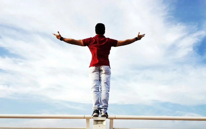 A man looking at the sky with open hands