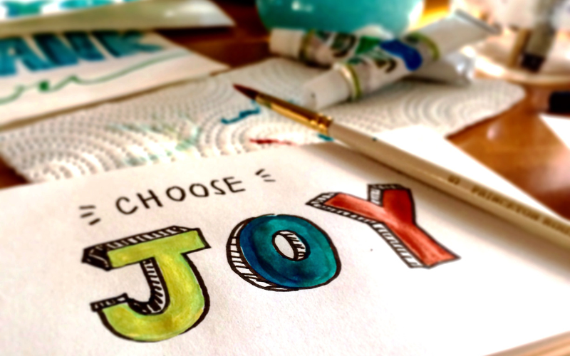 An artwork with choose joy text