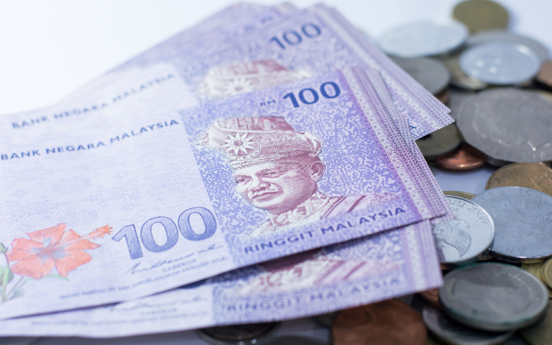 hundred Malaysian ringgits and coins