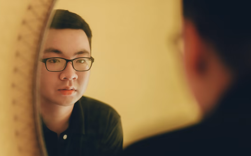 Man looking at a mirror