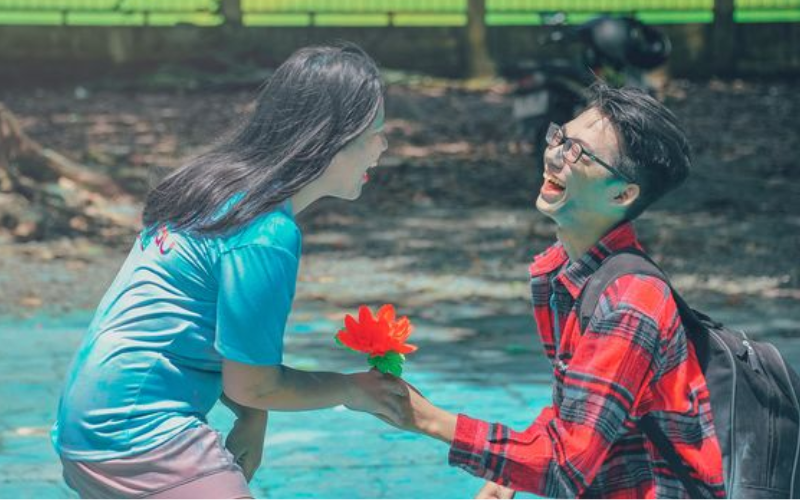 guy gifting a flower to a girl