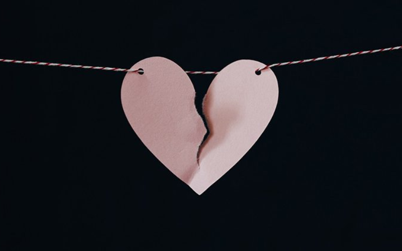 Broken heart made of paper tied to a string