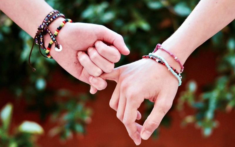Hands interlocked at the pinkies