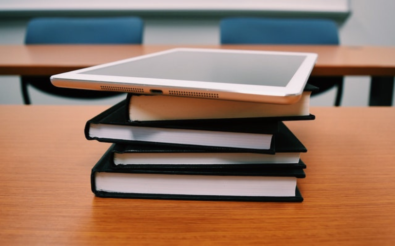 ipad and books on a table