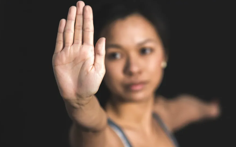 women showing stop hand pose