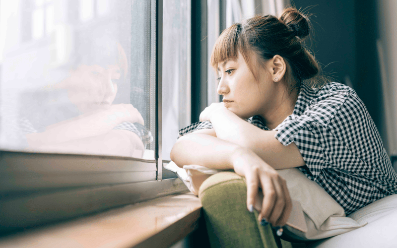 Woman looking unhappy at the window