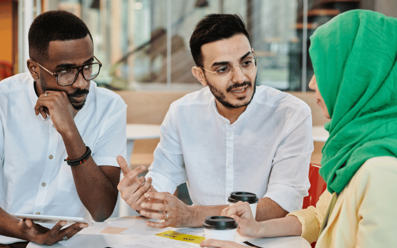 3 international figures converse with one another 