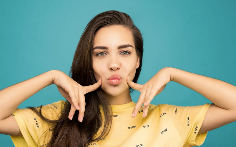 A girl pointing to her cheek