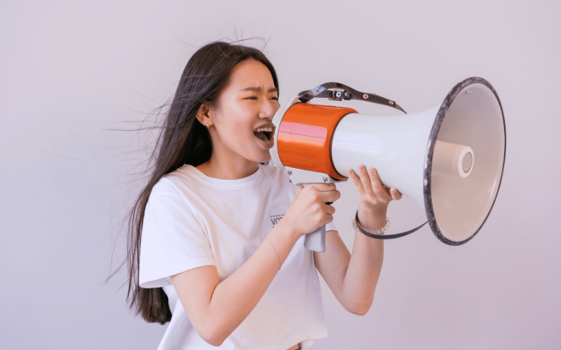 Woman yelling into megaphone