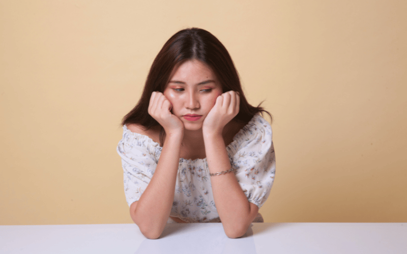 Lady thinking with hands on her face