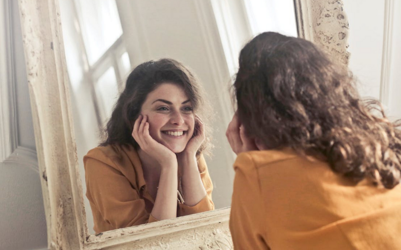 Woman looking at a mirror