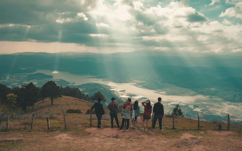 Group of people standing at a mountain