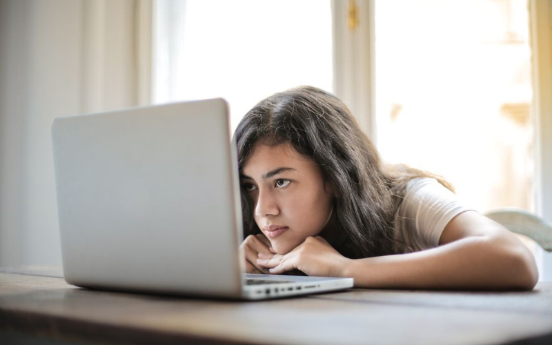 A girl looking at her laptop