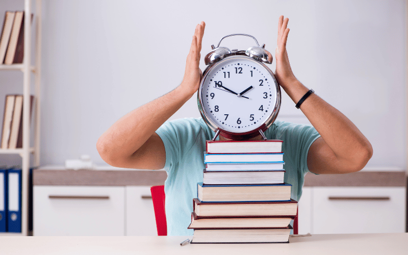 Clock placed on a pile of books