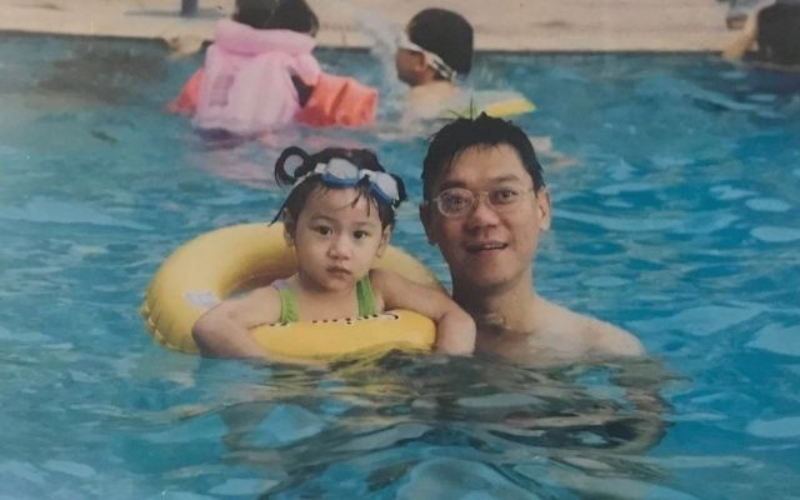 Father and daughter in a pool