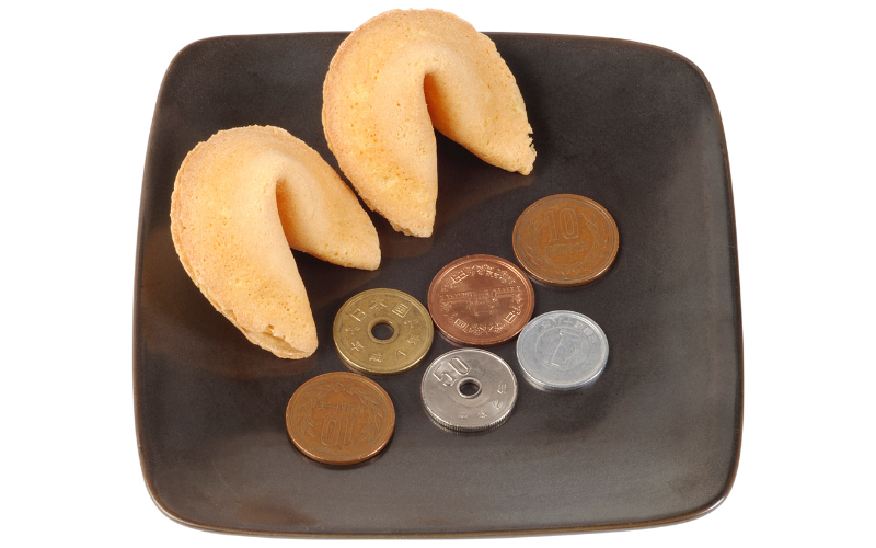 fortune cookies and coins on a plate