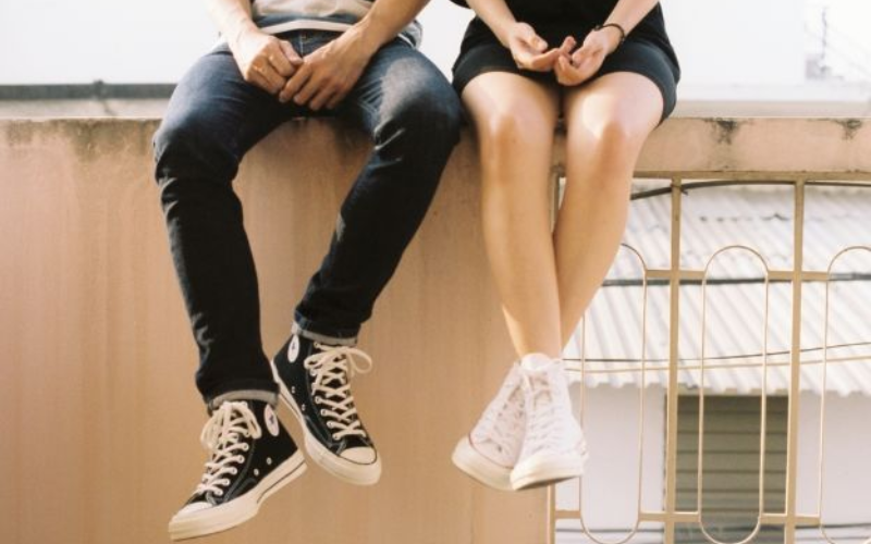Man and Woman legs hanging off a ledge