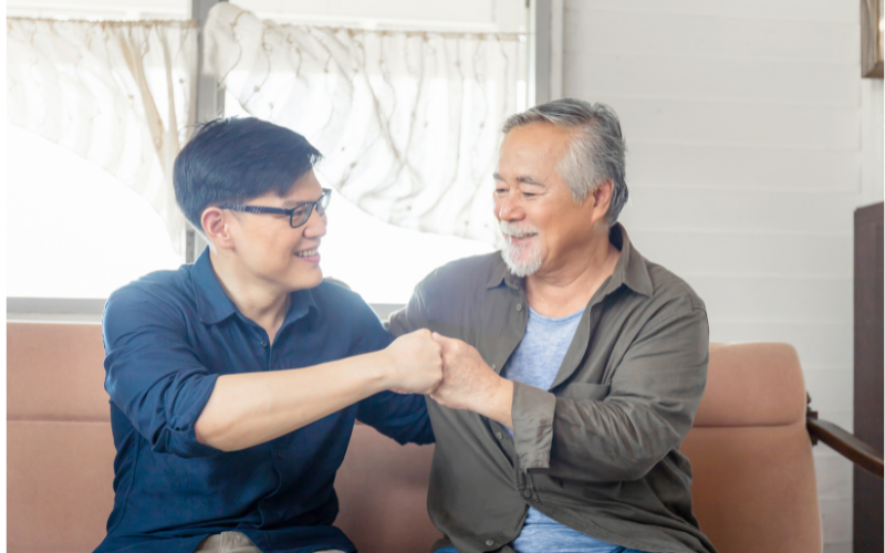 a man and grandpa fist bumping