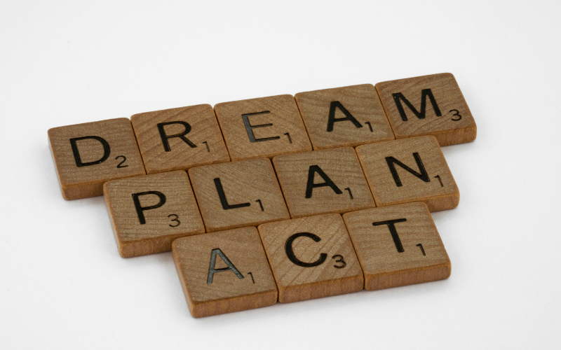 Scrabble blocks with the text "DREAM PLAN ACT"