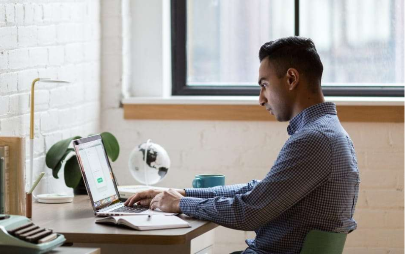man surfing the internet on a laptop