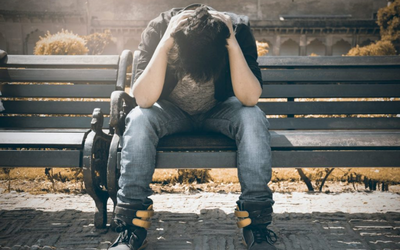 man stressing at a bench