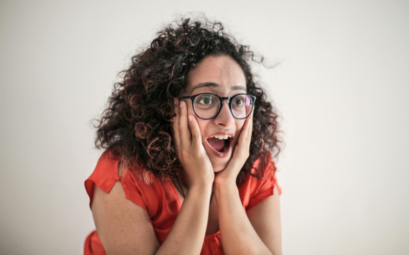 A curly-haired girl being taken aback