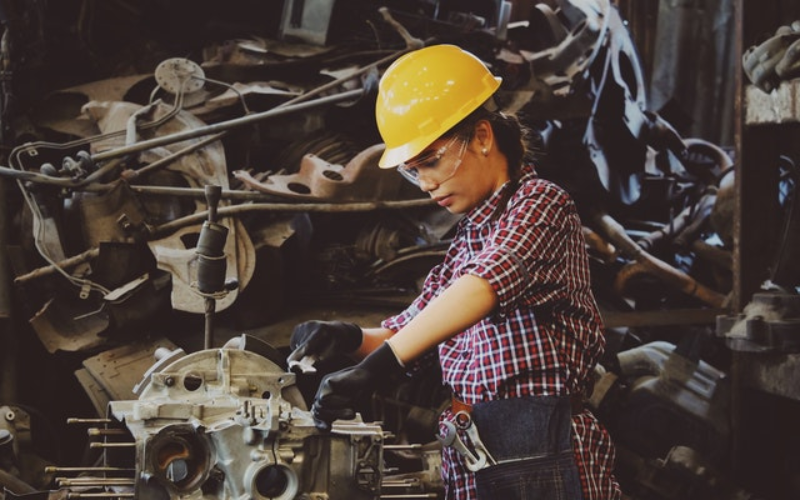 A girl is working on a machine