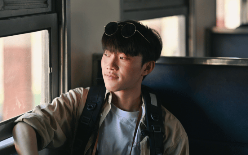 A man looks out of the window from his train