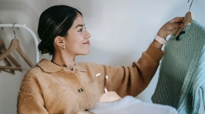 Woman happily looking at one of her clothes