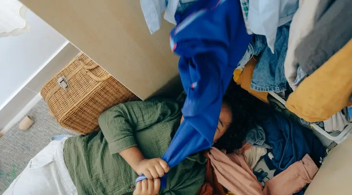 Woman laying down underneath her closet