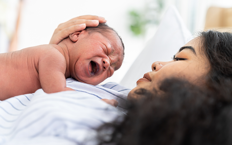 mother holding a crying baby