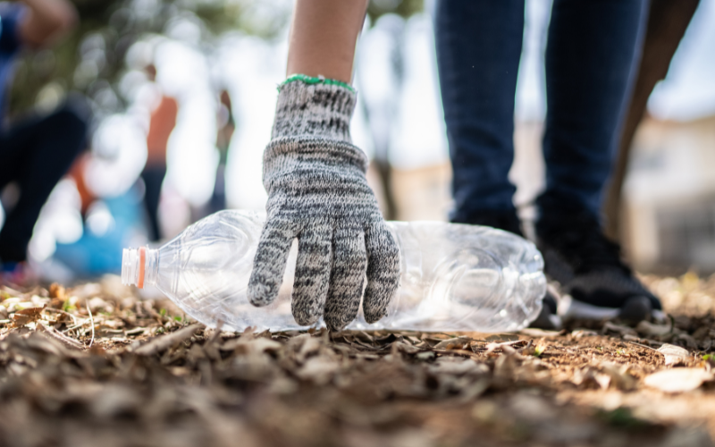 Hand picking up an empty bottle