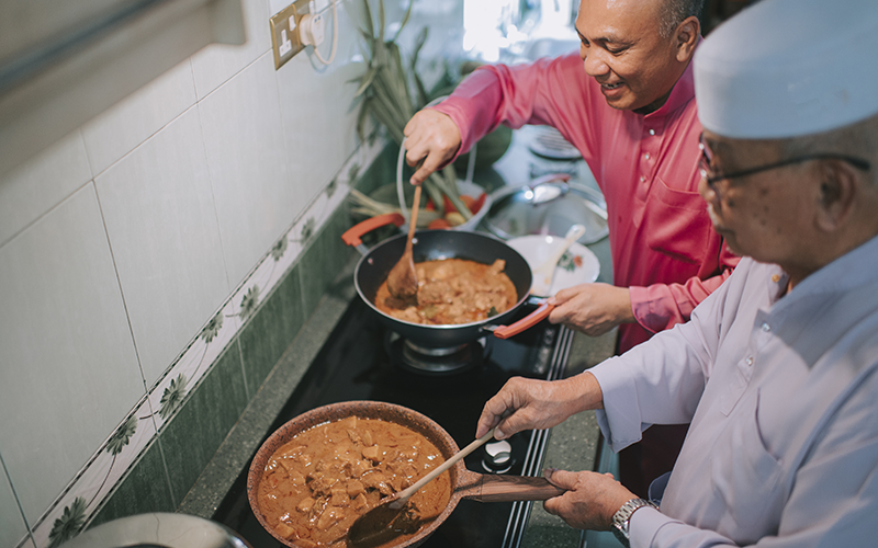 Father and grandfather cooking in a kitchen