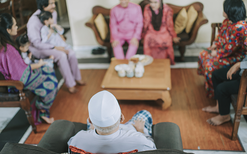 Family of multiple generations sitting in a living room
