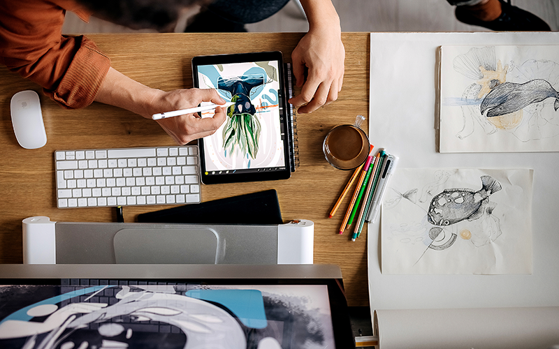 Graphic designer creating digital artwork on a tablet